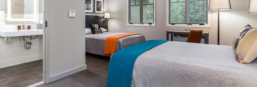 What are the main differences between 1440 Multiversity and a hotel?